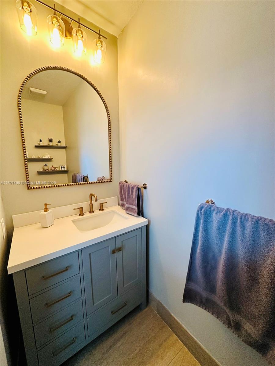 3961 Antigua Point Drive Boca Raton, FL 33487 - Photo 23 of 65 a bathroom with a sink and a mirror