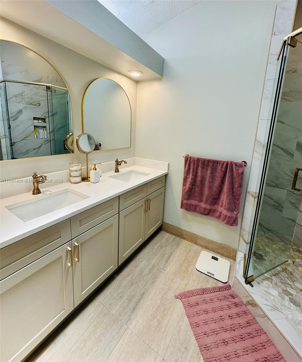 3961 Antigua Point Drive Boca Raton, FL 33487 - Photo 35 of 65 a en suite bathroom with a double vanity sink and a mirror