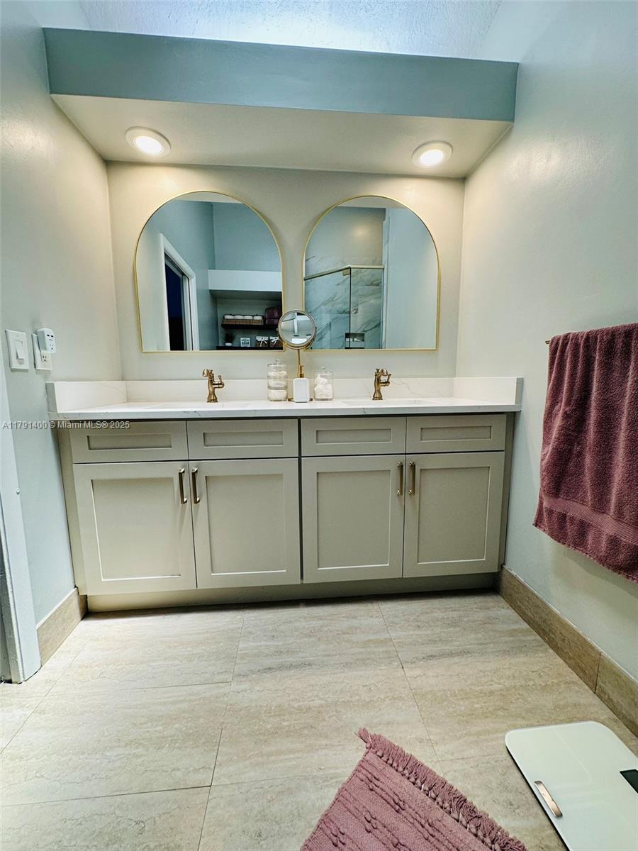 3961 Antigua Point Drive Boca Raton, FL 33487 - Photo 36 of 65 a large bathroom with a double vanity sink and a mirror