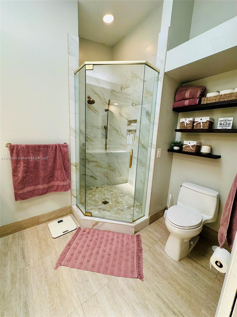 3961 Antigua Point Drive Boca Raton, FL 33487 - Photo 37 of 65 a bathroom with a toilet and a shower