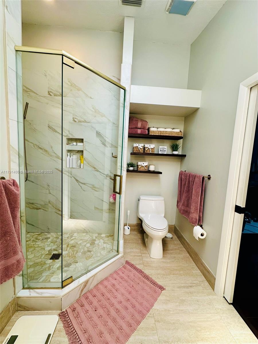 3961 Antigua Point Drive Boca Raton, FL 33487 - Photo 39 of 65 a bathroom with a toilet and a shower
