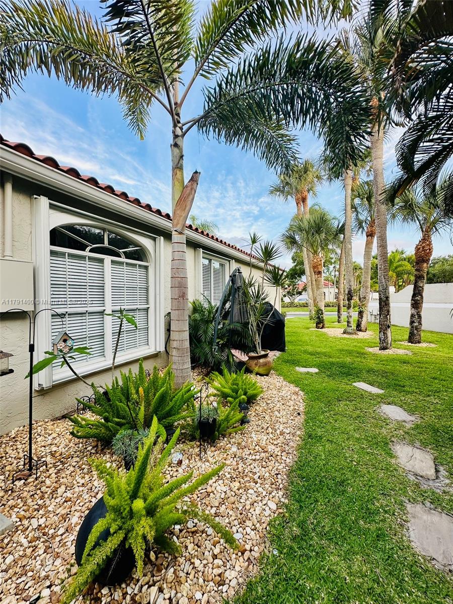 3961 Antigua Point Drive Boca Raton, FL 33487 - Photo 47 of 65 a front view of a house with garden