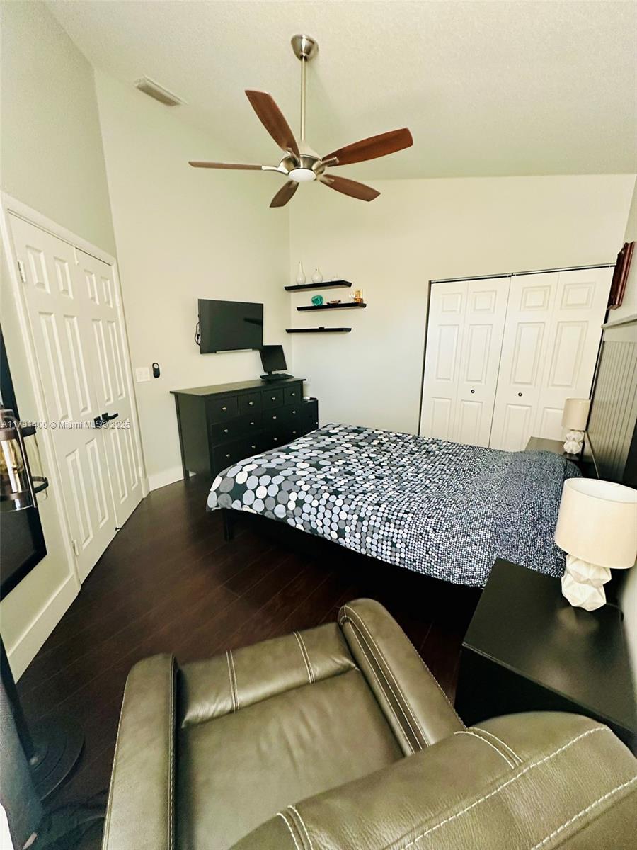 3961 Antigua Point Drive Boca Raton, FL 33487 - Photo 49 of 65 a bedroom with a bed and a dresser with wooden floor