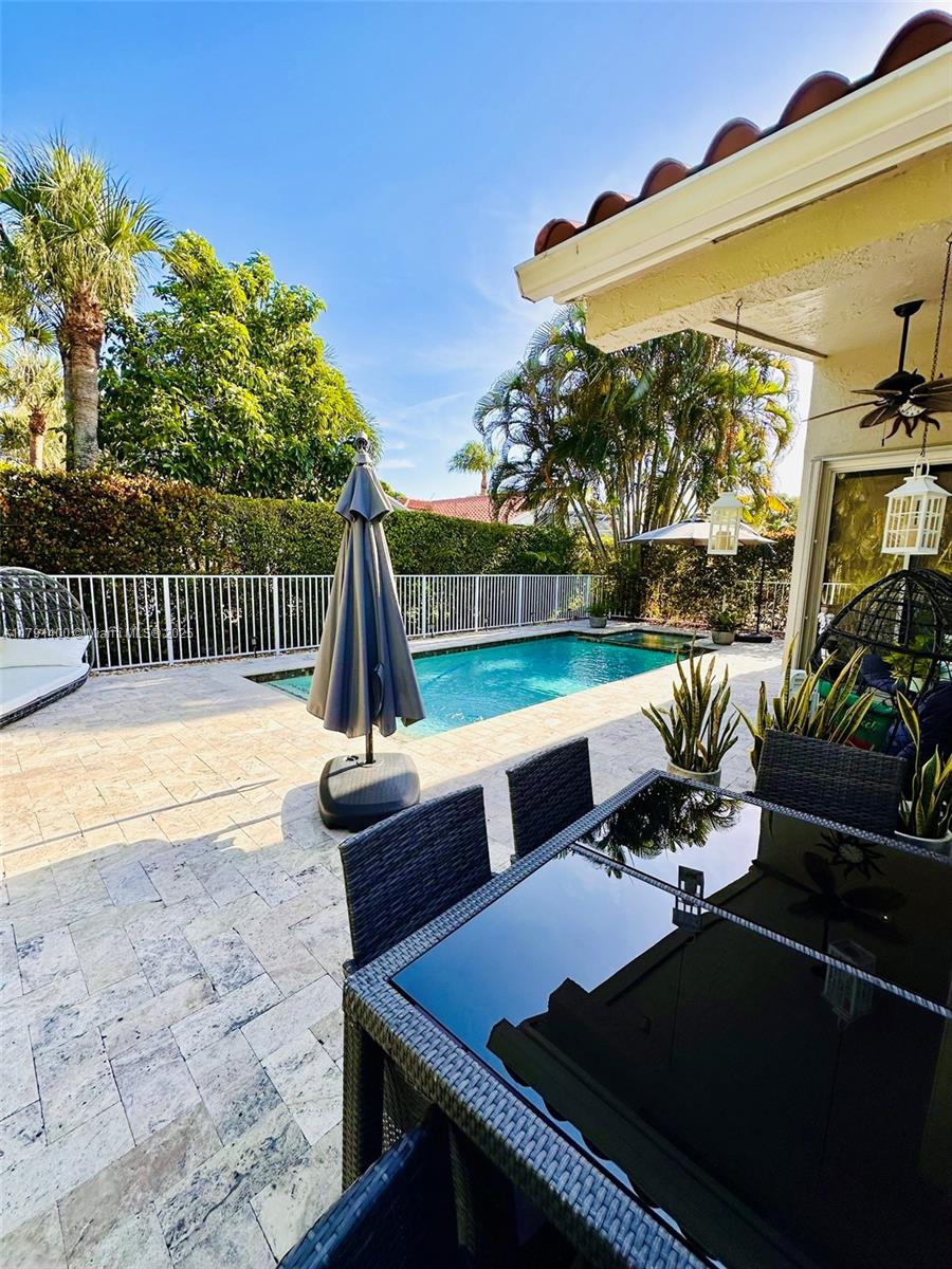 3961 Antigua Point Drive Boca Raton, FL 33487 - Photo 58 of 65 a view of a patio with table and chairs potted plants with wooden floor