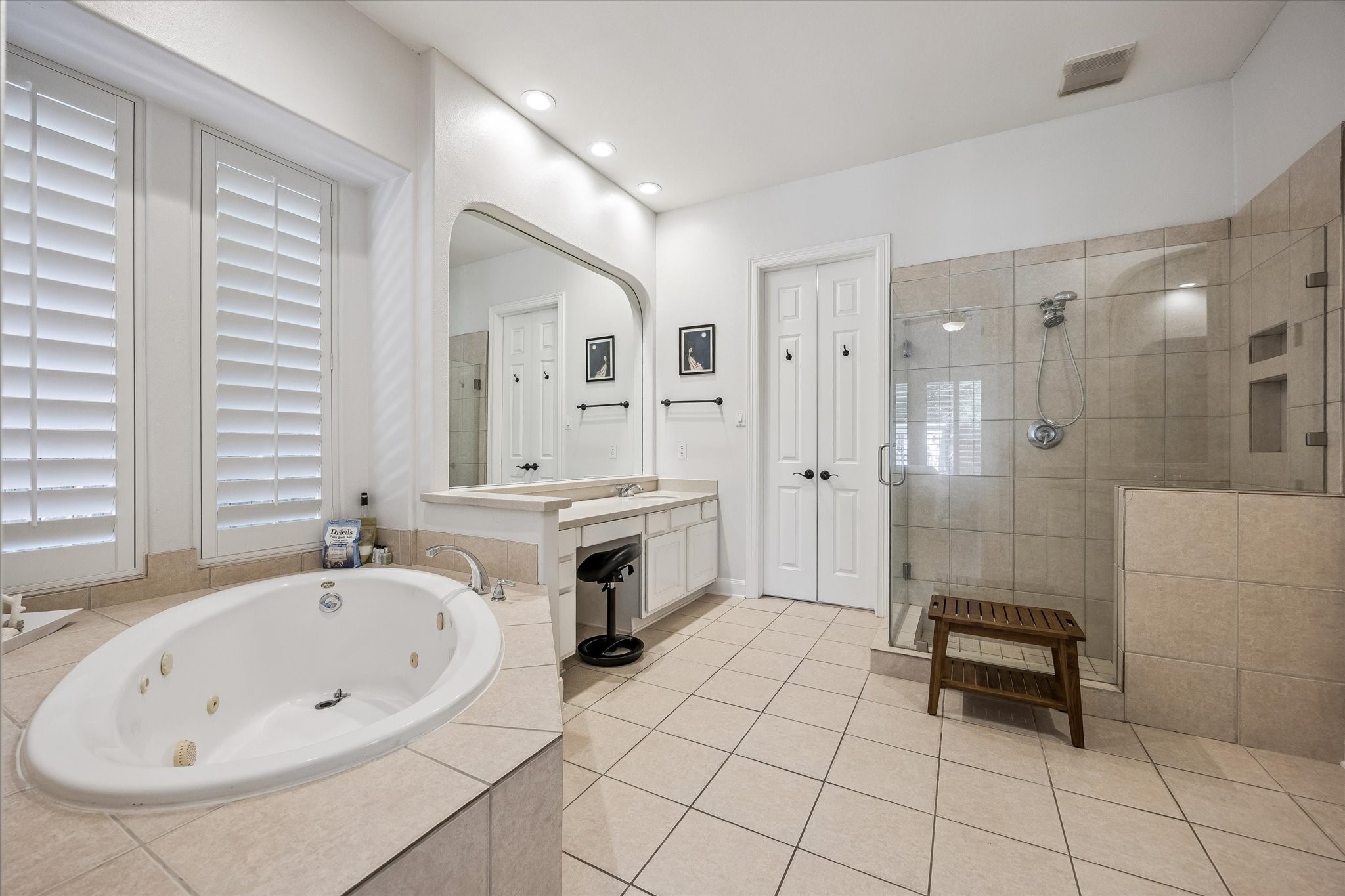3047 Bonnebridge Way Boulevard Houston, TX 77082 - Photo 37 of 50 This primary spa-inspired bathroom features a relaxing whirlpool tub, a standalone glass-enclosed shower, dual vanities, and an expansive walk-in master closet.