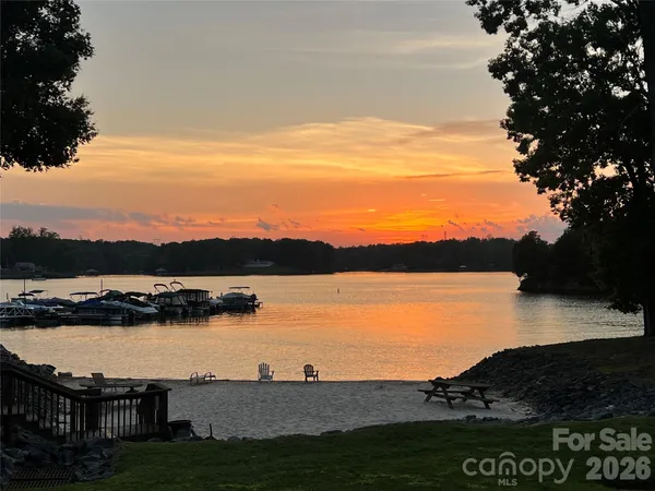 a view of a lake with couches in the patio