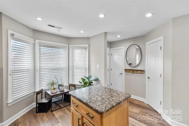 a living room with kitchen island furniture and a window