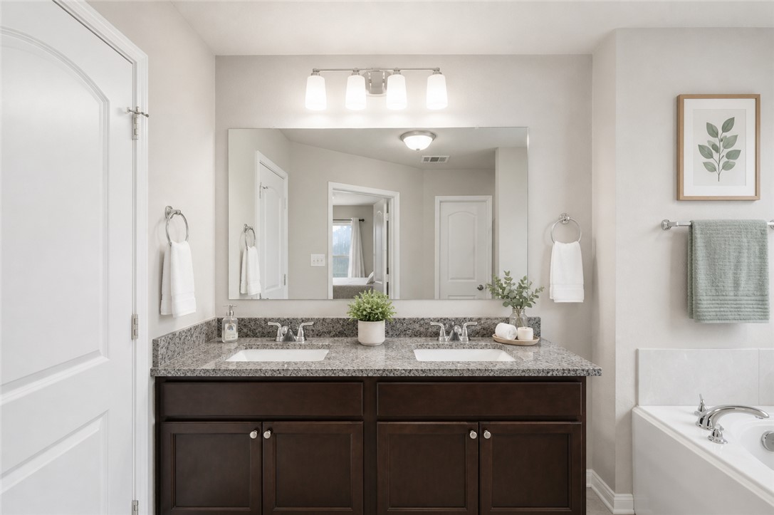 2725 Porter's Way Bryan, TX 77803 - Photo 12 of 19 a bathroom with a sink and a mirror