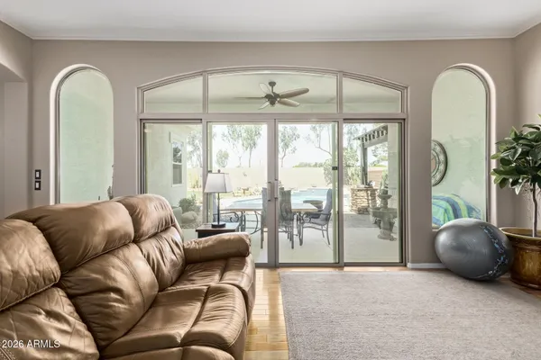 a living room with furniture and floor to ceiling window