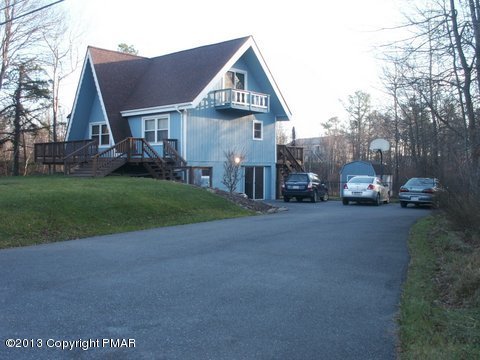 1138 Clover Road Long Pond, PA 18334 - Photo 1 of 23 a front view of a house with a yard and garage