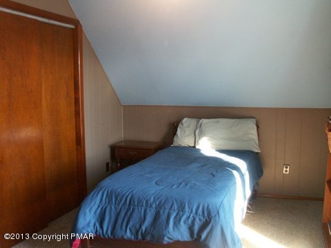 1138 Clover Road Long Pond, PA 18334 - Photo 12 of 23 a bed sitting in a bedroom next to a wooden door