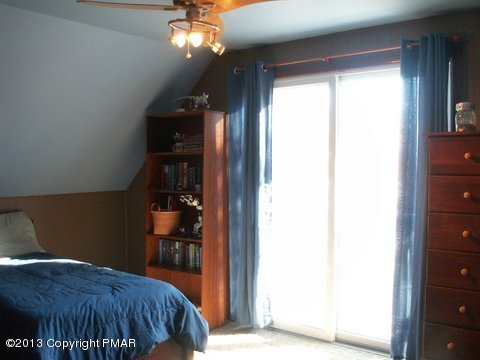 1138 Clover Road Long Pond, PA 18334 - Photo 13 of 23 a bedroom with a bed and a chandelier
