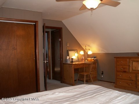 1138 Clover Road Long Pond, PA 18334 - Photo 14 of 23 a room with a mirror and a wooden floor