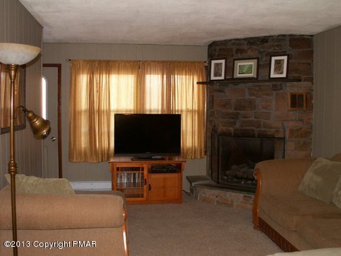 1138 Clover Road Long Pond, PA 18334 - Photo 16 of 23 a living room with furniture and a flat screen tv