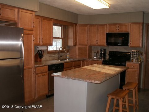 1138 Clover Road Long Pond, PA 18334 - Photo 6 of 23 a kitchen with a sink refrigerator and microwave