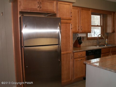 1138 Clover Road Long Pond, PA 18334 - Photo 7 of 23 a kitchen with a refrigerator and a sink