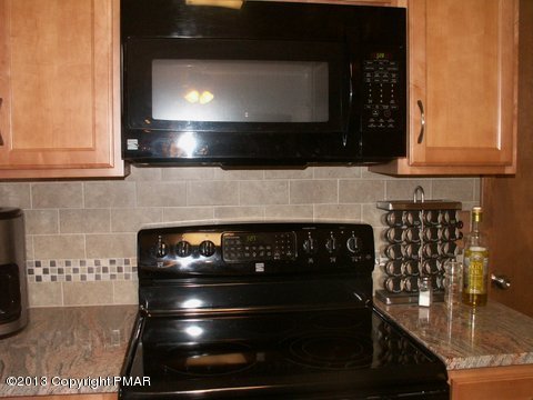 1138 Clover Road Long Pond, PA 18334 - Photo 8 of 23 a kitchen with granite countertop stove top oven and cabinets