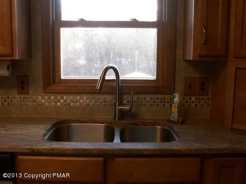 1138 Clover Road Long Pond, PA 18334 - Photo 9 of 23 a bathroom with a sink a window and cabinets