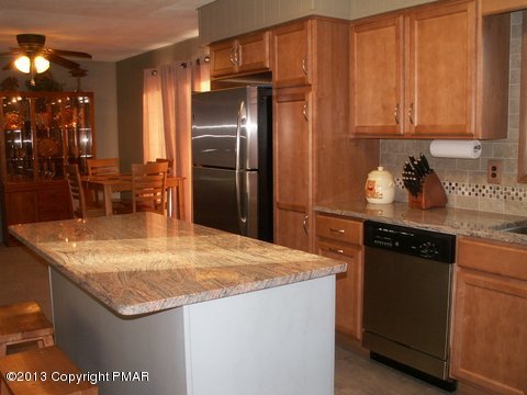 1138 Clover Road Long Pond, PA 18334 - Photo 10 of 23 a kitchen with stainless steel appliances granite countertop a sink a refrigerator and a stove
