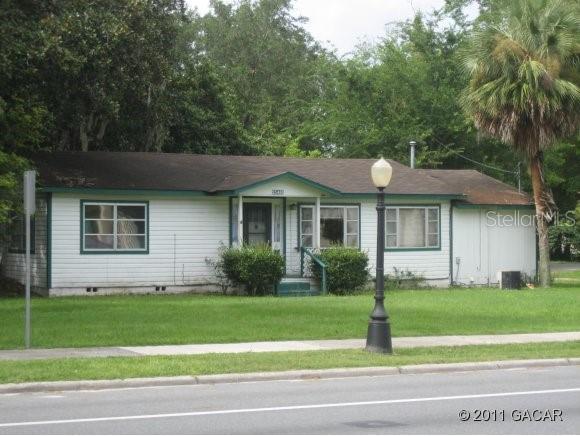 25461 West Newberry Road Newberry, FL 32669 - Photo 1 of 1 a front view of a house with a garden and yard