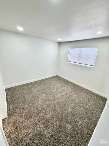 an empty room with a rug