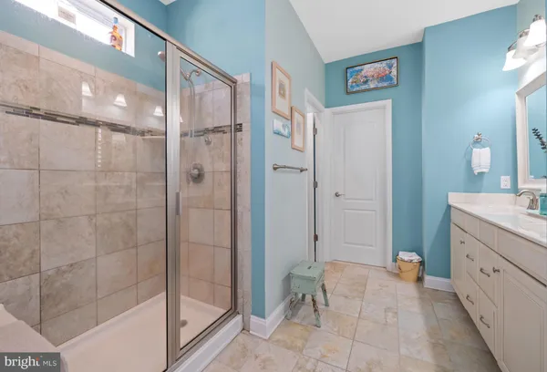 a bathroom with a double vanity sink a mirror and a bathtub