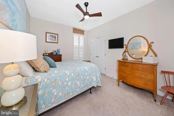 a bathroom with a granite countertop sink a mirror and a bathtub