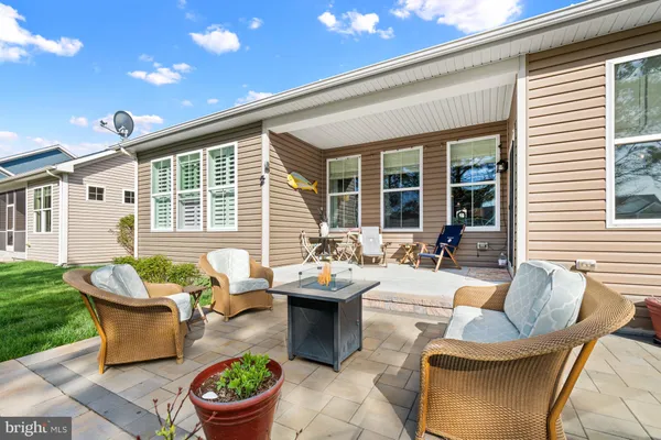 a view of a patio with couches chairs and a fire pit