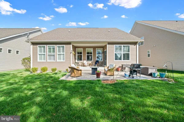 a view of a backyard with sitting area