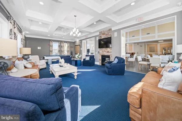 a living room with furniture large window and flat screen tv