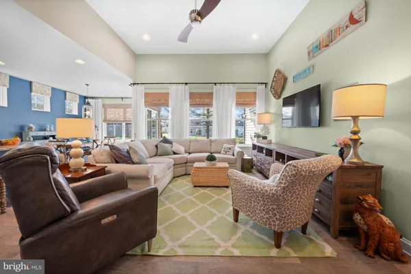 a living room with furniture a rug and a lamp