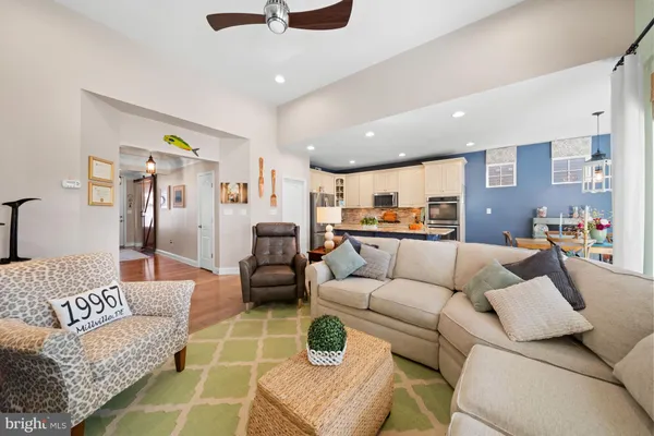 a living room with furniture and kitchen view