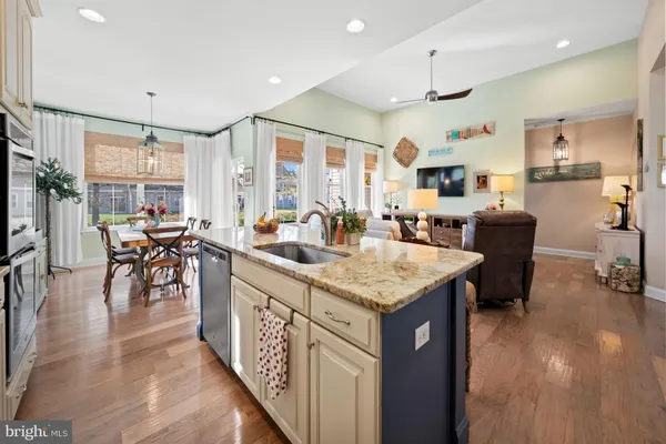 a kitchen with stainless steel appliances kitchen island granite countertop a stove a sink and a microwave