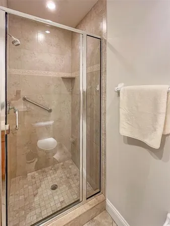 a bathroom with a glass shower door