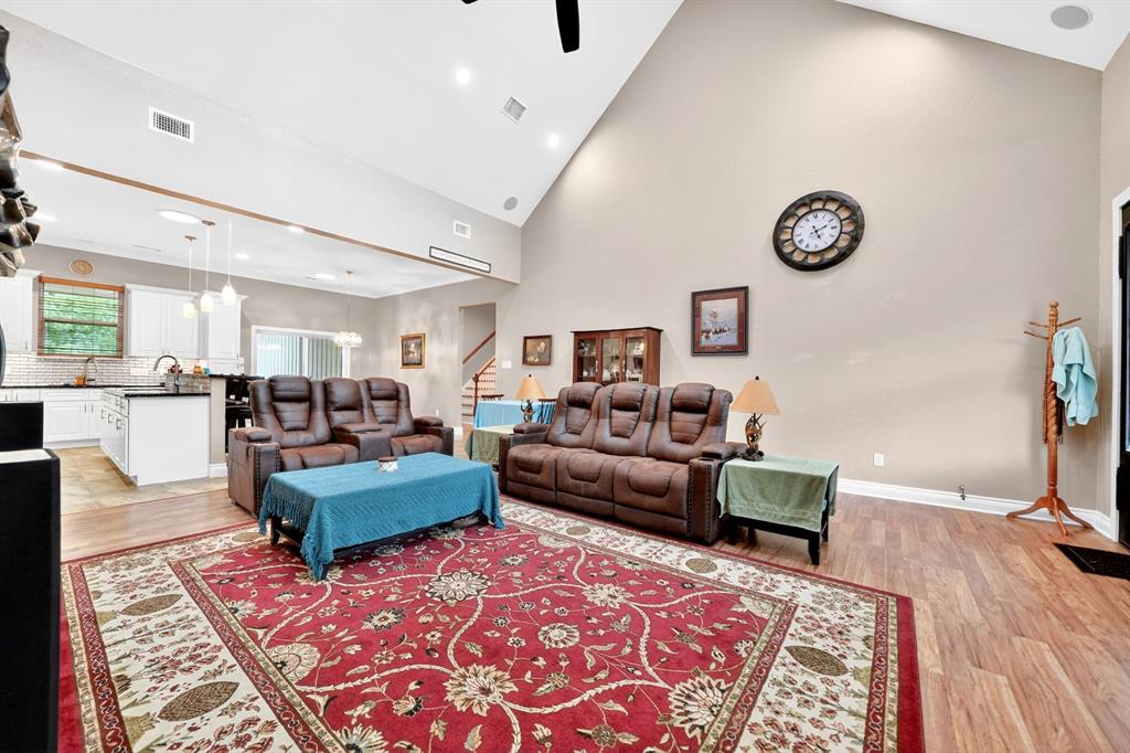 5230 Esquire Estates Road Mabank, TX 75156 - Photo 8 of 39 Spacious living area featuring vaulted ceilings, recessed lighting, and wood-finish flooring