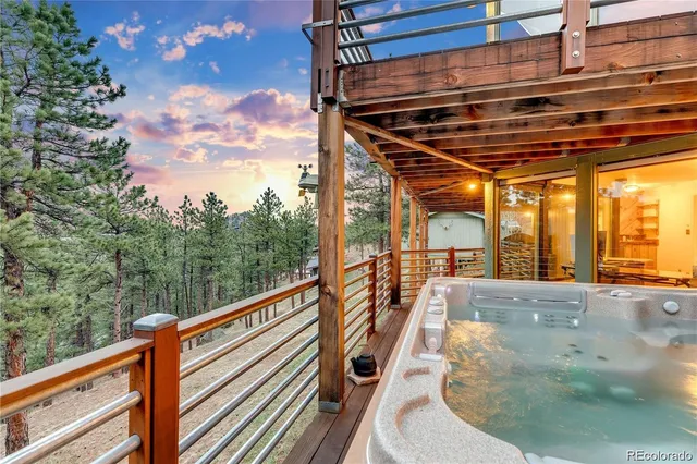 a dining hall with stainless steel appliances granite countertop a sink a counter space wooden floor and living room view