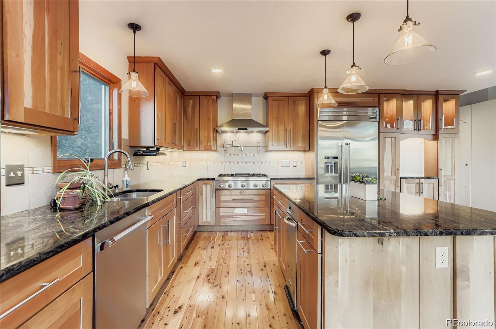 994 Timber Lane Boulder, CO 80304 - Photo 12 of 21 a kitchen with stainless steel appliances granite countertop a sink a stove and a wooden floors