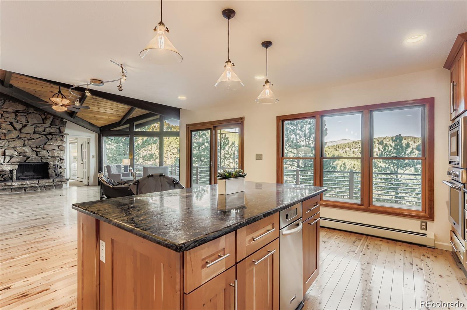 994 Timber Lane Boulder, CO 80304 - Photo 13 of 21 a dining hall with stainless steel appliances granite countertop a sink a counter space wooden floor and living room view