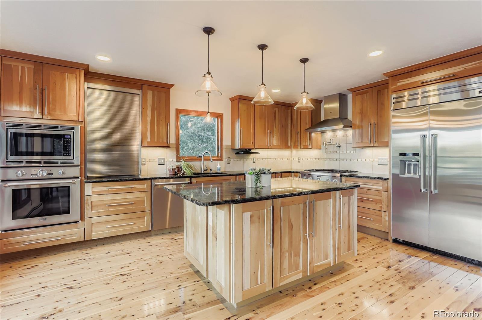 994 Timber Lane Boulder, CO 80304 - Photo 14 of 21 a kitchen with stainless steel appliances granite countertop a stove a sink and a refrigerator