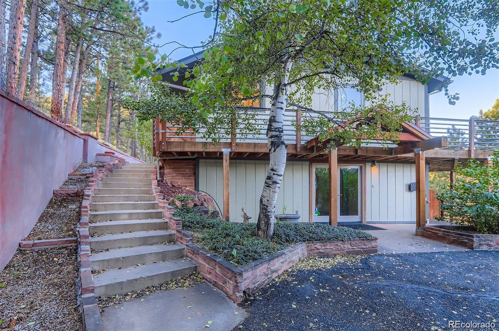 994 Timber Lane Boulder, CO 80304 - Photo 6 of 21 a front view of a house with a garden
