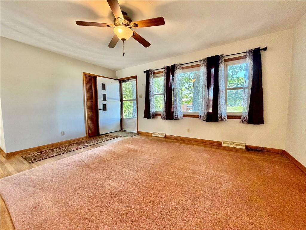 121 Kemar Drive Butler, PA 16002 - Photo 4 of 31 a view of an empty room with a window and a kitchen