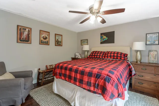 a bedroom with a large bed and a couch