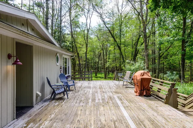 a backyard of a house with table and chairs