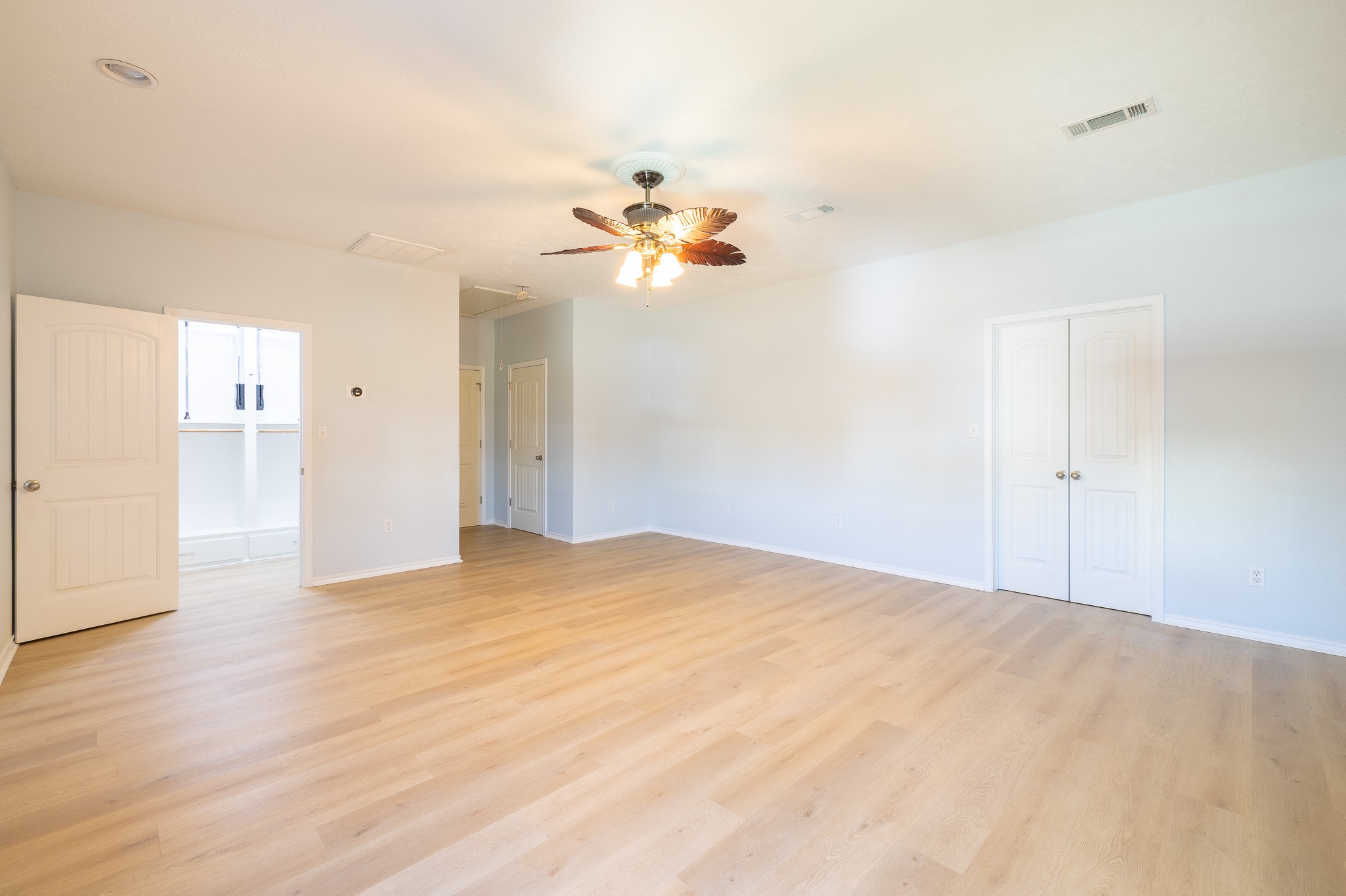 1991 Gulf Crystal Beach, TX 77650 - Photo 11 of 20 a view of a big room with wooden floor and a chandelier fan