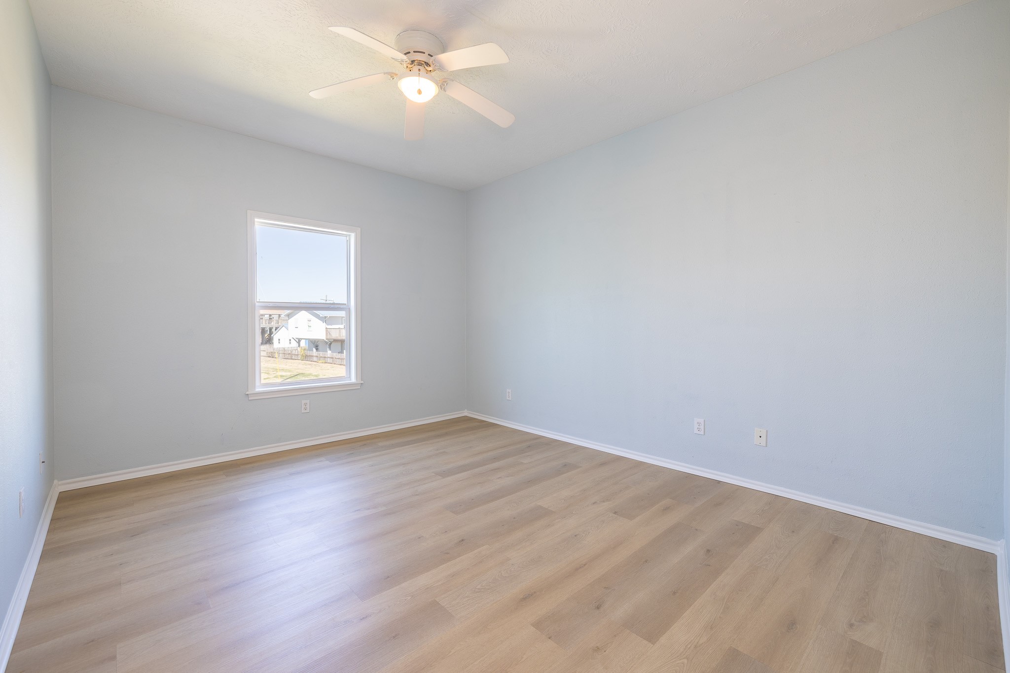 1991 Gulf Crystal Beach, TX 77650 - Photo 10 of 20 an empty room with a window and ceiling fan