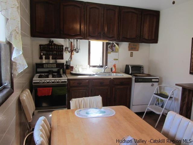76 Tamarack Road Greenfield Park, NY 12435 - Photo 7 of 13 a kitchen with stainless steel appliances a stove a sink a microwave a refrigerator and cabinets