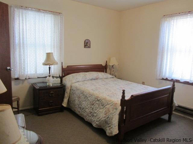 76 Tamarack Road Greenfield Park, NY 12435 - Photo 8 of 13 a bedroom with a bed and a lamp