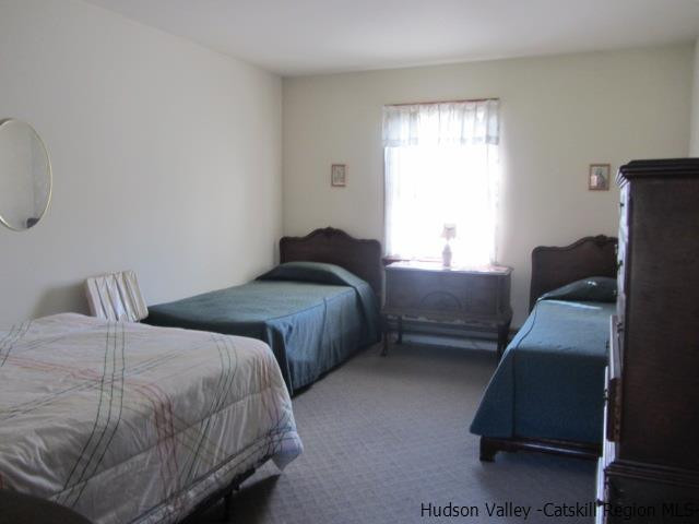 76 Tamarack Road Greenfield Park, NY 12435 - Photo 9 of 13 a bedroom with two beds and a window