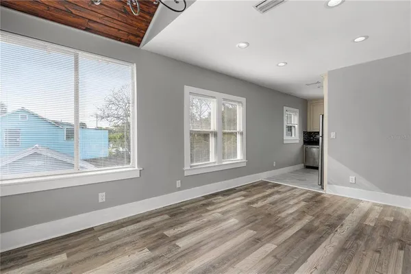a view of a kitchen with an empty space and a window