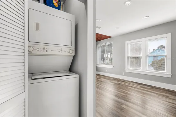 a kitchen with granite countertop white cabinets and appliances